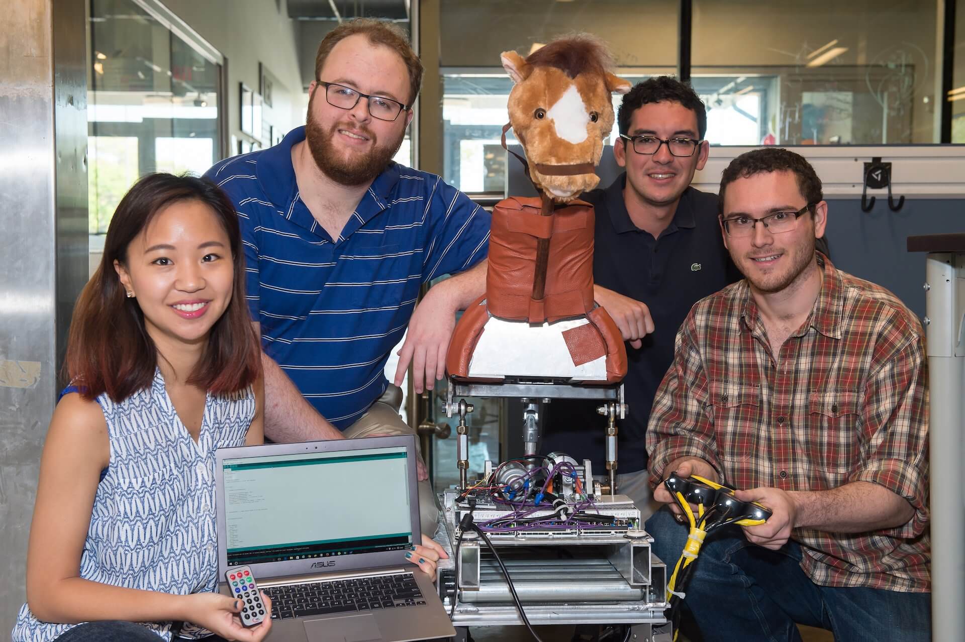 The Hippo Riders team of Rice University engineering students has created a horse simulator for use by hippotherapy patients. From left: Amy Ryu, Erik Hansen, Jaime Gomez and Brett Berger. (Credit: Jeff Fitlow/Rice University)