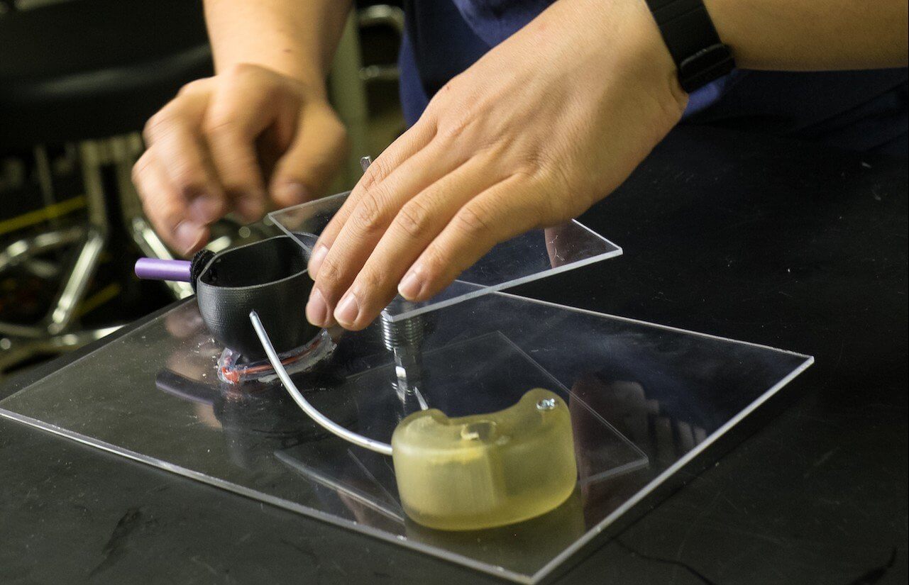 Rice engineering student John Chen reloads a test rig to demonstrate a method developed by Rice University students that uses a strong, tiny magnetic bead to help remove a ureteral stent from a child. (Credit: Jeff Fitlow)