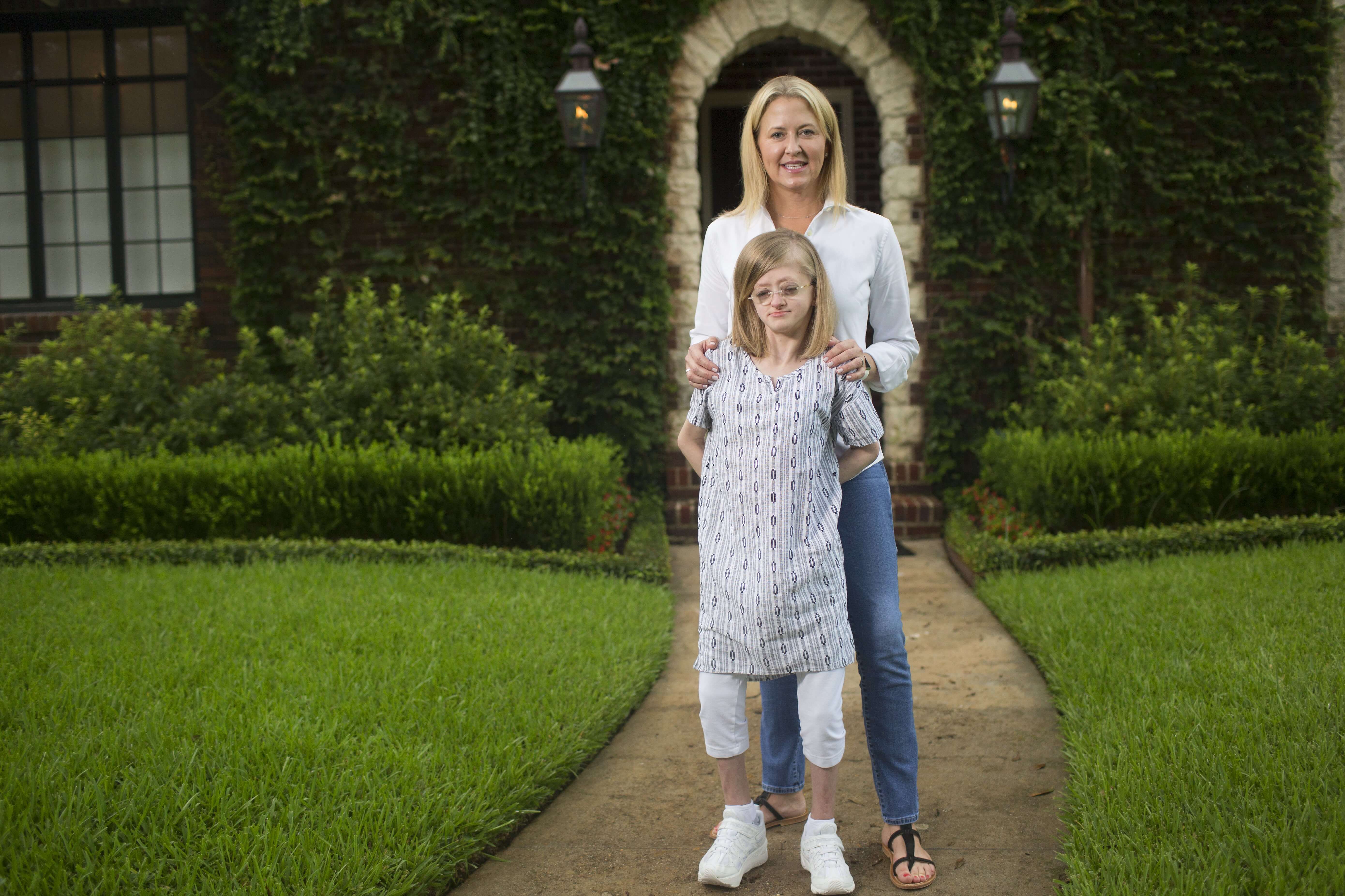 Andersson Dyke and her mother, Sarah, outside their Houston home. Andersson, 15, has osteogenesis imperfecta.