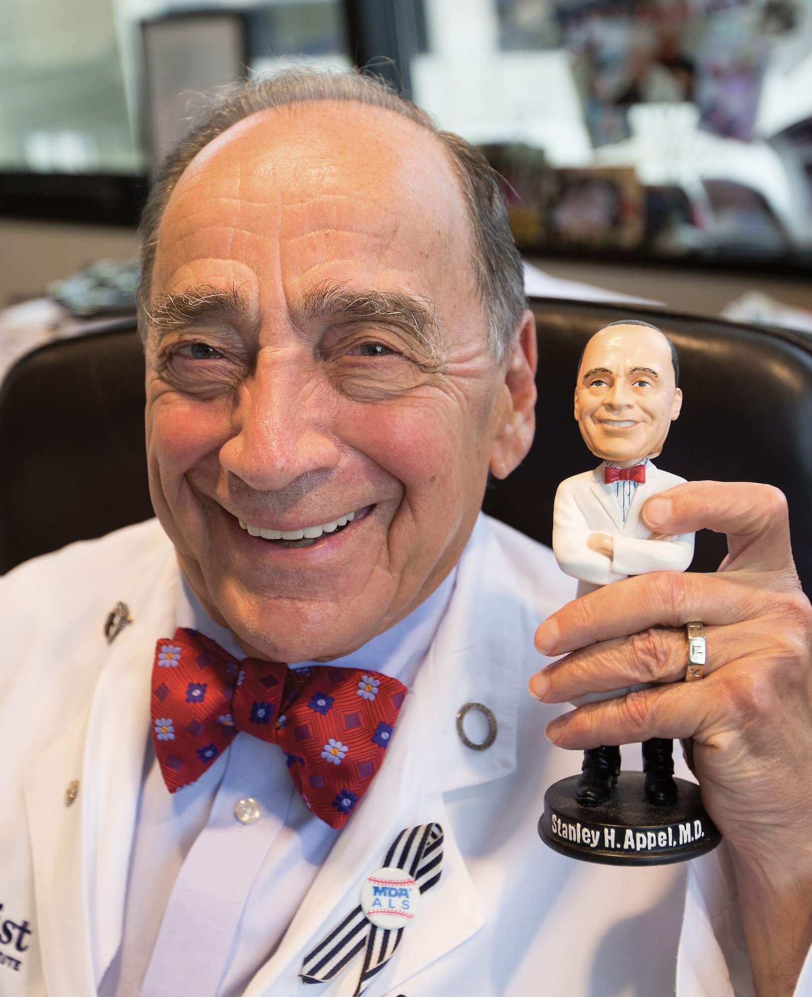 The office of Stanley Appel, M.D., is decorated with an extensive variety of awards, souvenirs and gifts, including this bobblehead, given to him by his wife and son for his 75th birthday.