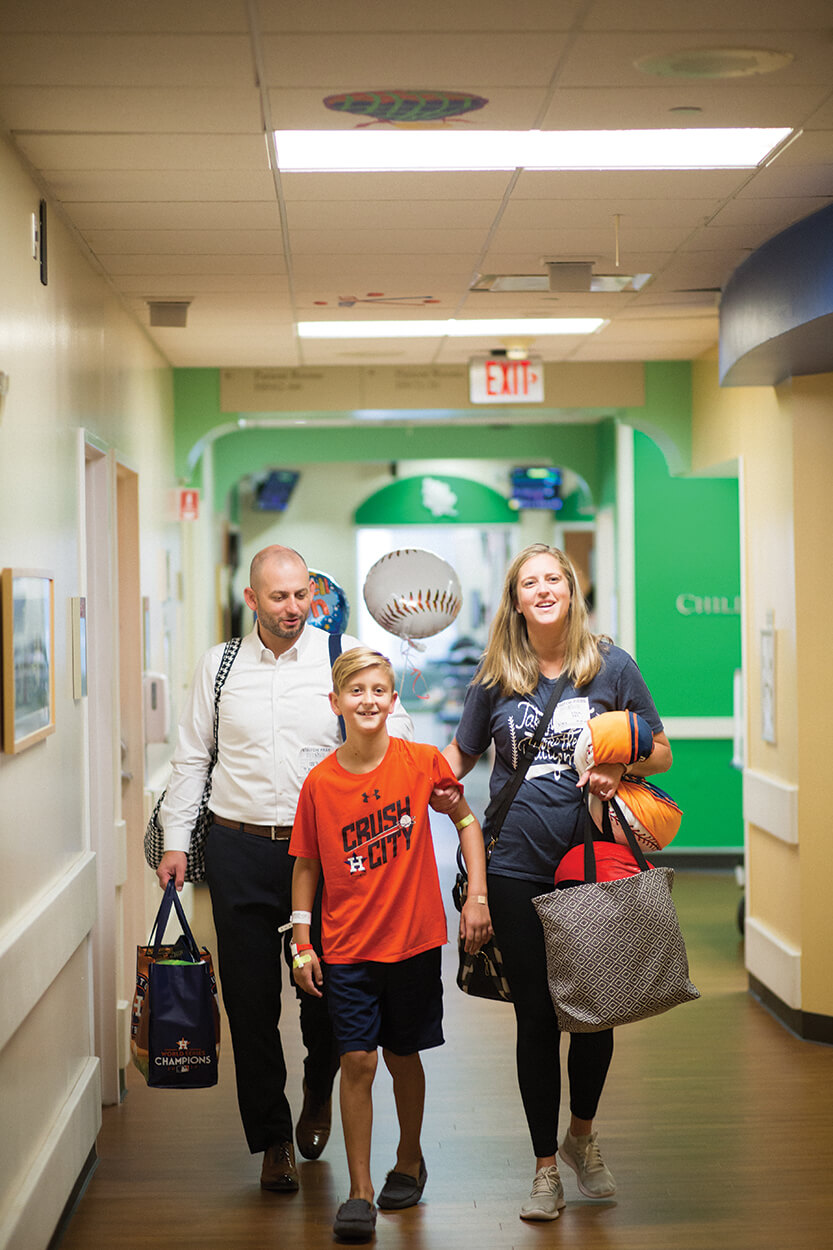 Ethan Page leaves the hospital with his parents, Brent and Julie Page, four days after his surgery.