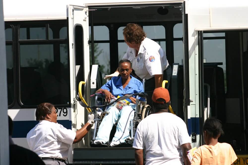 An evacuee is unloaded from a bus. (Photo courtesy Harris Health System)