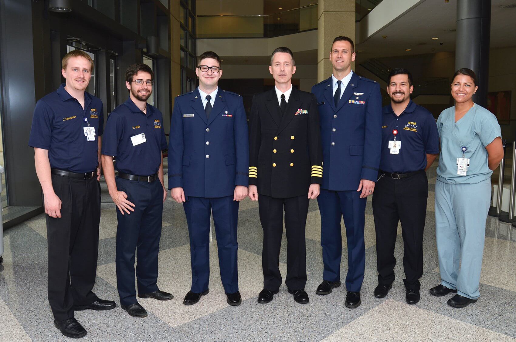 Air Force Capts. Cecil Roberts, M.D., third from left, and Tim Soeken, M.D., third from right, were promoted during a commissioning ceremony in the DeBakey Library and Museum. (Credit: Baylor College of Medicine)