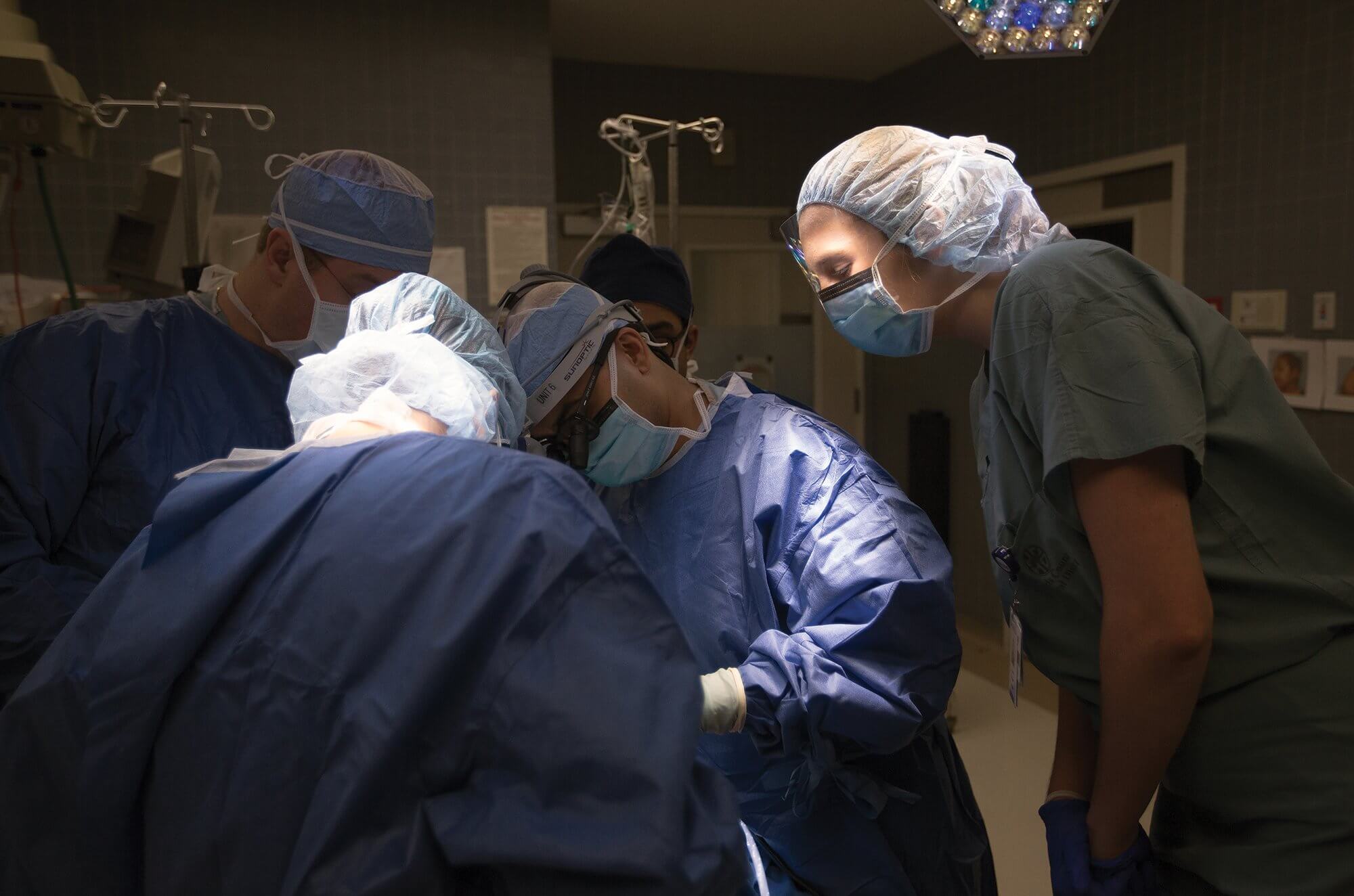 Reppert peers over the shoulders of Baylor College of Medicine surgeons during a nasal reconstruction at Ben Taub Hospital.