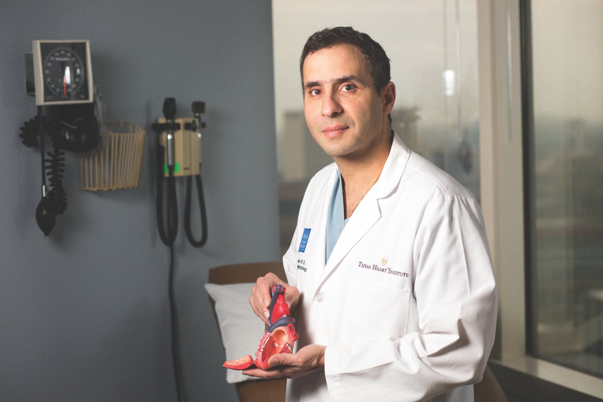 Mehdi Razavi, M.D., director of clinical arrhythmia research and innovation at Texas Heart Institute, holds a heart model.