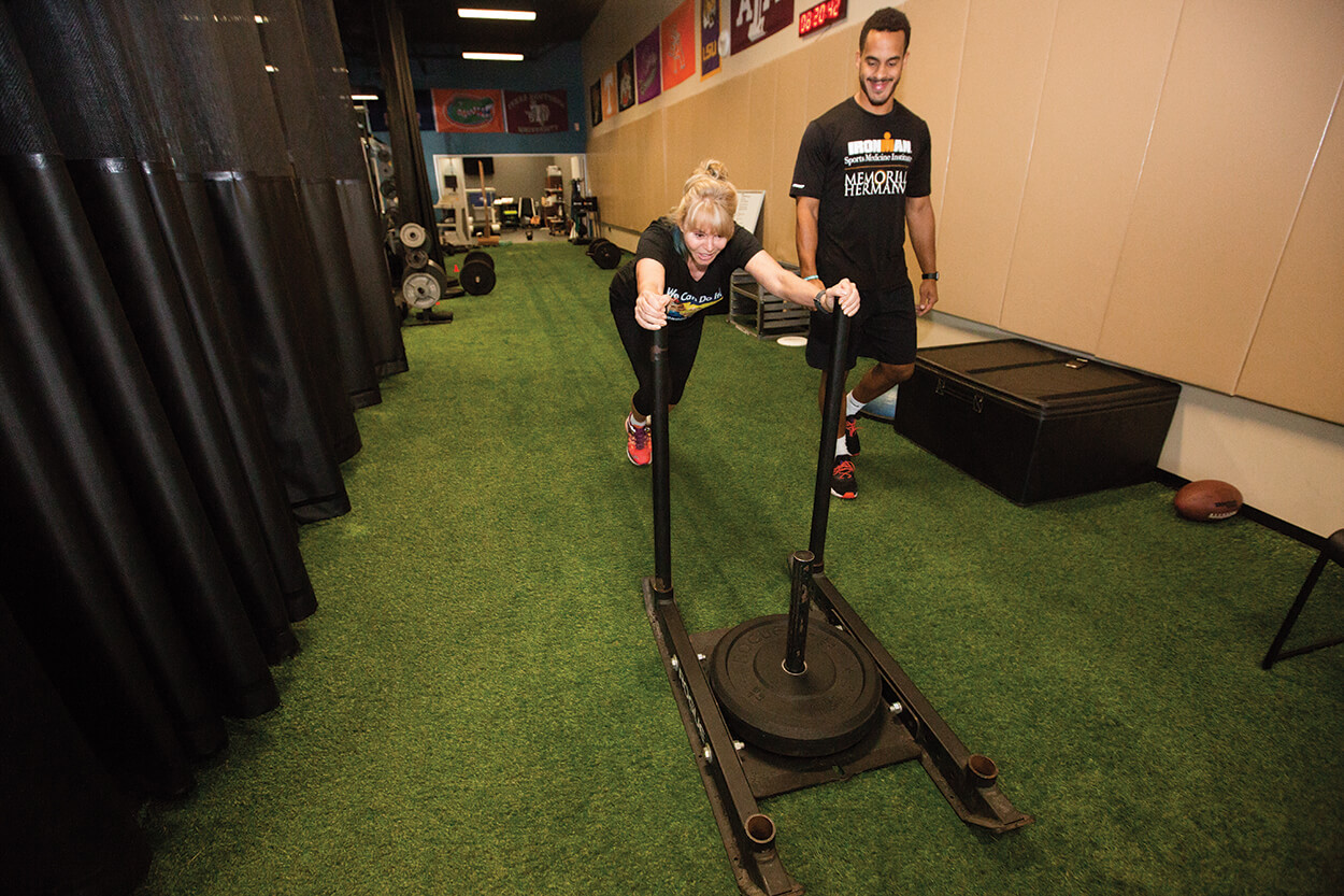 Hoepfel works out with her trainer, Chris Slocum, a senior performance coach with Athlete Training and Health and Memorial Hermann IRONMAN Sports Medicine Institute.