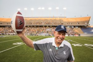Dr. Leland Winston, orthopedic surgeon at Houston Methodist, waves to the crowd holding the game ball award he was presented with during the Rice vs. Baylor football game for his 50 years of service and commitment to the Rice community, at Rice Stadium in Houston, TX on Friday September 16, 2016. (Photo/Scott Dalton)