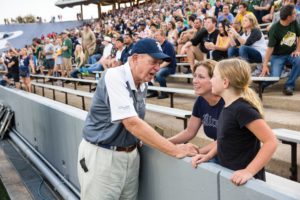 Dr. Leland Winston, orthopedic surgeon at Houston Methodist, greets his daughter and granddaughter on the sidelines during the Rice vs. Baylor football game at Rice Stadium in Houston, TX on Friday September 16, 2016. Dr. Winston was honored with a game ball at the game for his 50 years of service and commitment to the Rice community, (Photo/Scott Dalton)