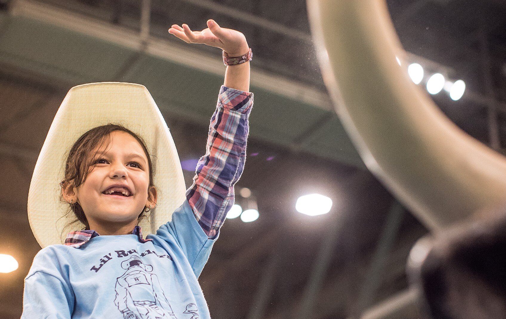 Avaya, 8, waves to the crowd at the Lil’ Rustlers Rodeo.