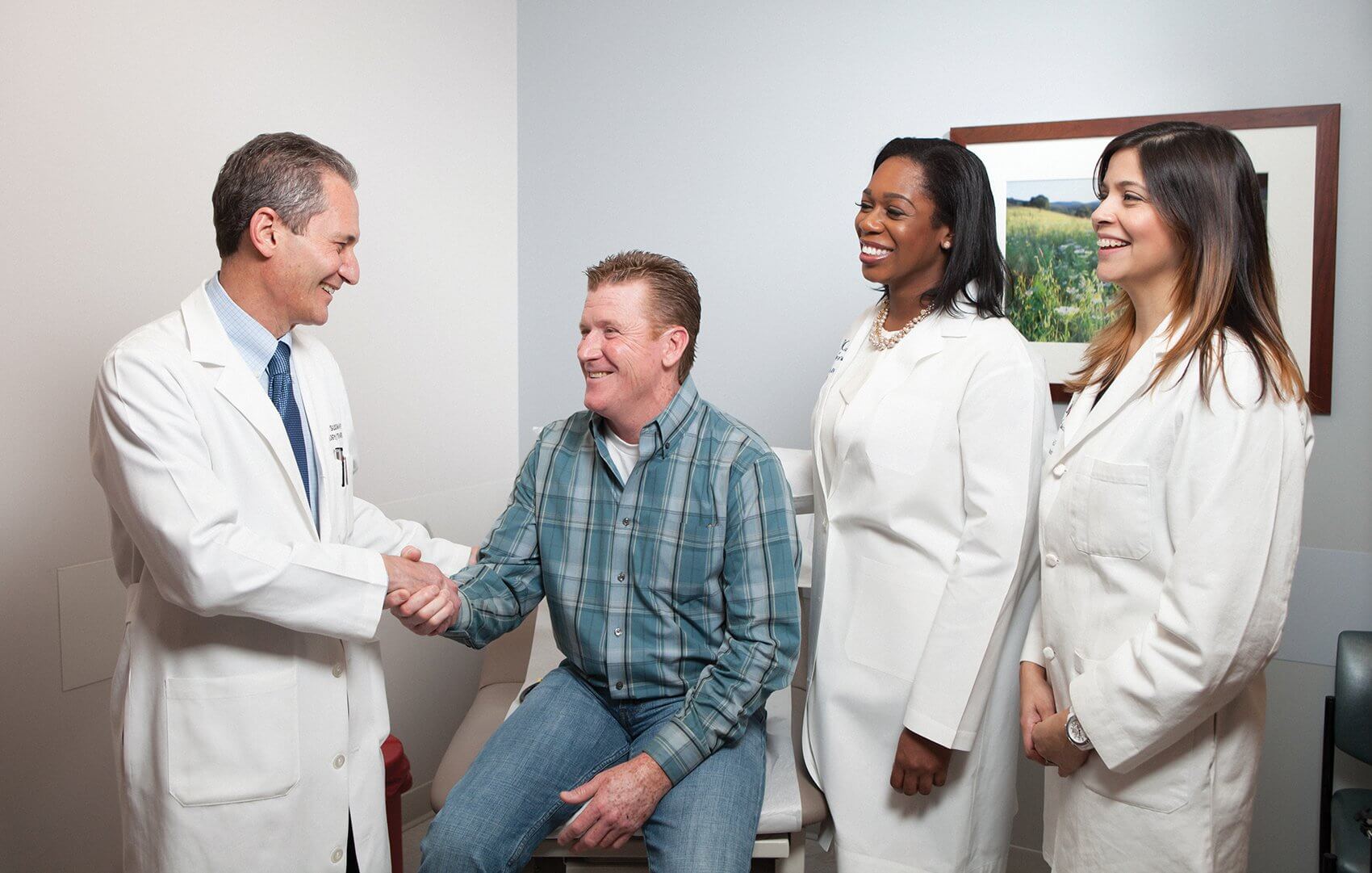 From left, Norman Sussman, M.D., director of Project ECHO, and patient John Rocks met for the first time after Rocks was cured of hepatitis C. Pictured with Renita Madu, the physician assistant who directly treated Rocks, and Project ECHO associate director Saira Khaderi, M.D.