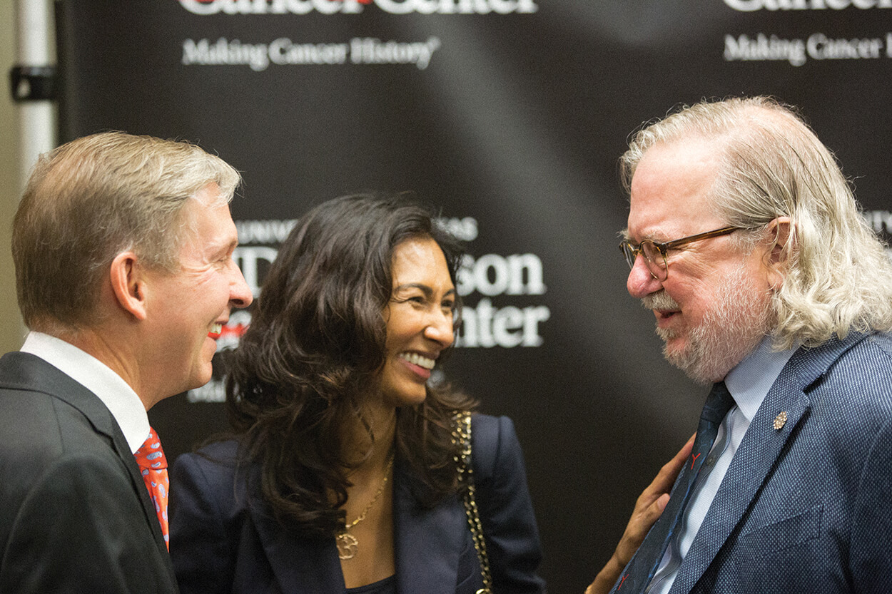MD Anderson president Peter Pisters, M.D., left, speaks with Allison and his wife, Padmanee Sharma, M.D., Ph.D., professor in the department of genitourinary medical oncology at MD Anderson, during a press conference In October 2018.