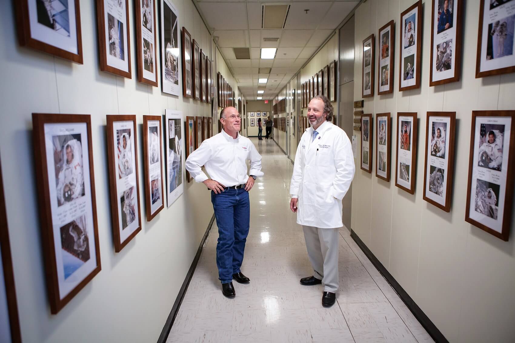 Rick Scheuring, D.O., flight surgeon for NASA and the Johnson Space Center, and Patrick McCulloch, M.D., orthopedic surgeon at Houston Methodist Hospital, walk the halls at NASA after a recent Wednesday clinic.