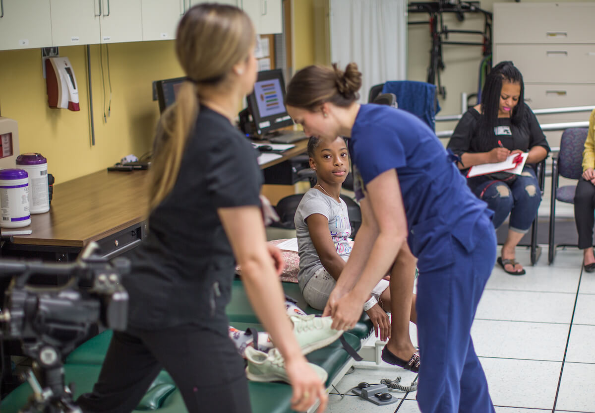Madilyn Jenkins begins a post-operative exam in the motion analysis center at Shriners Houston while her mother, Latonia Jenkins, completes forms on May 6, 2019. (Photo by Nick de la Torre)