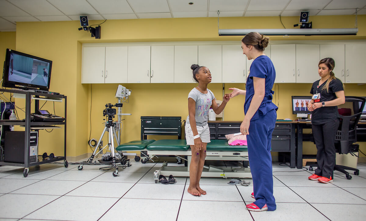 Madilyn Jenkins, 9½, receives directions from physical therapist Melissa Howard during a post-operative exam in the motion analysis center at Shriners Houston on May 6, 2019. (Photo by Nick de la Torre)