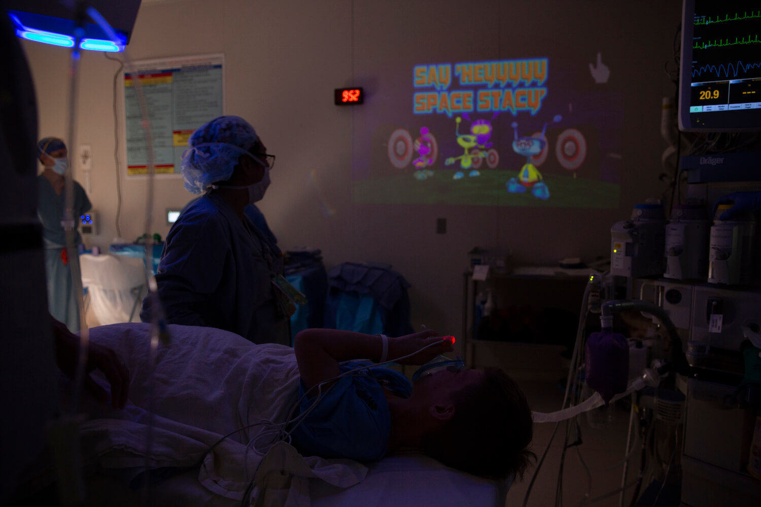 Charlie Pennell, 10, holds an anesthesia mask to his mouth while playing an interactive game in the operating room at Texas Children's Hospital.